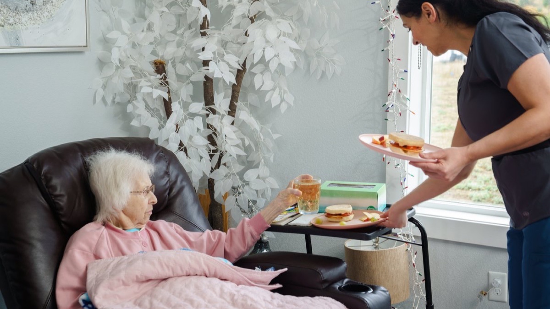 Caregiver supporting residents at A+ Quality Adult Family Home